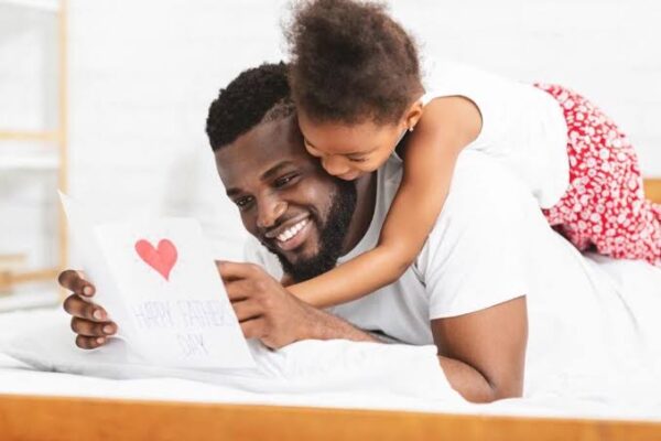 Family surprising dad with a thoughtful Father's Day gift at home
