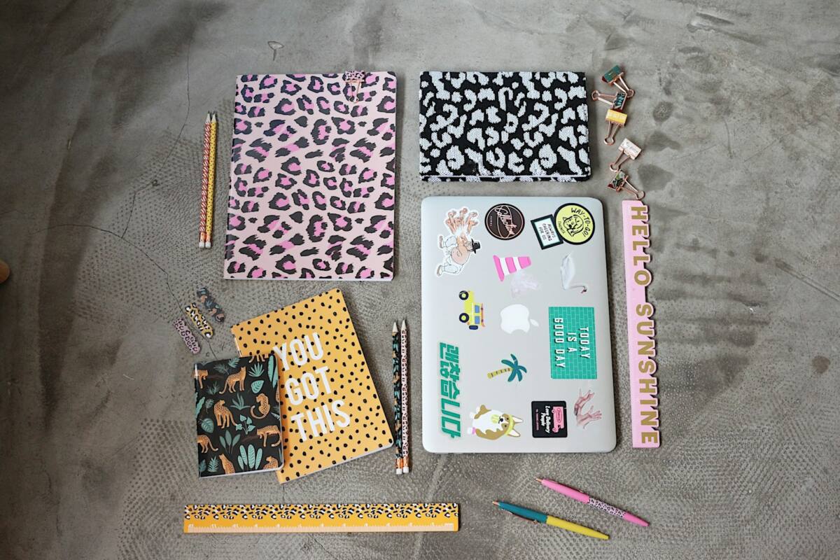 Back to school phone case ideas: supplies flatlay with notebooks