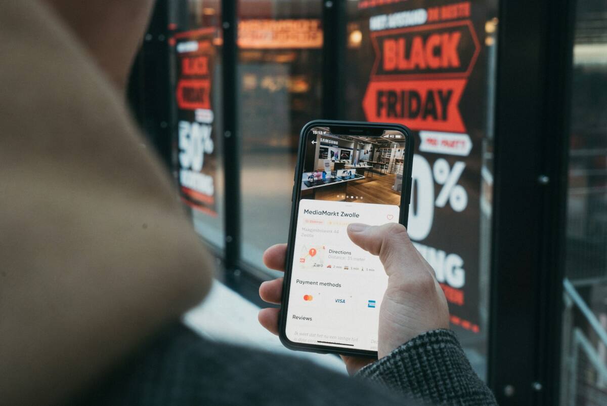 Black Friday Cyber Monday phone case deals: person checking deals on their phone during the holiday shopping weekend