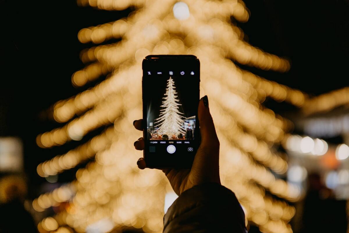 Christmas phone case design ideas: photographing Christmas tree lights on a phone for a custom case