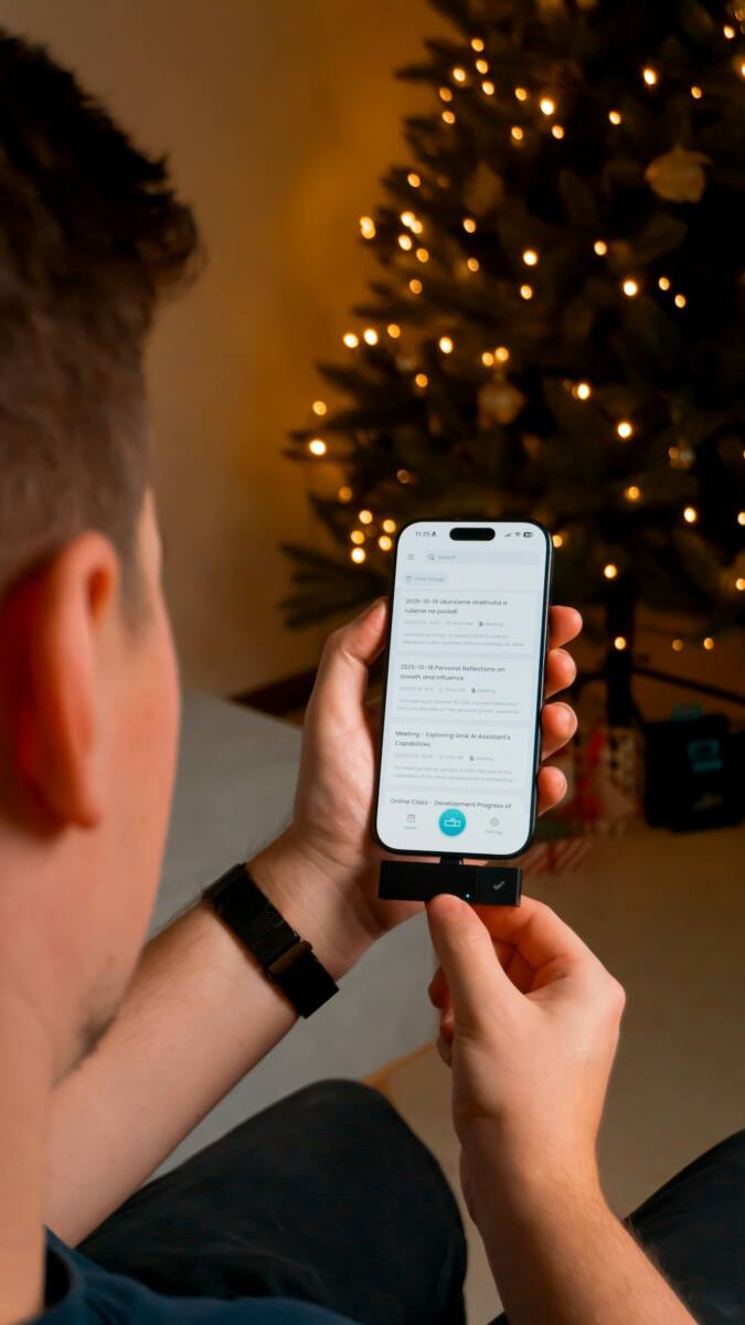 Using a phone near a decorated Christmas tree, matching a custom holiday phone case design