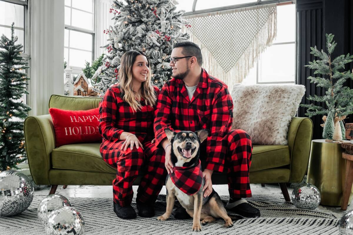 Matching family Christmas phone cases: couple in matching Christmas pajamas showing the same idea