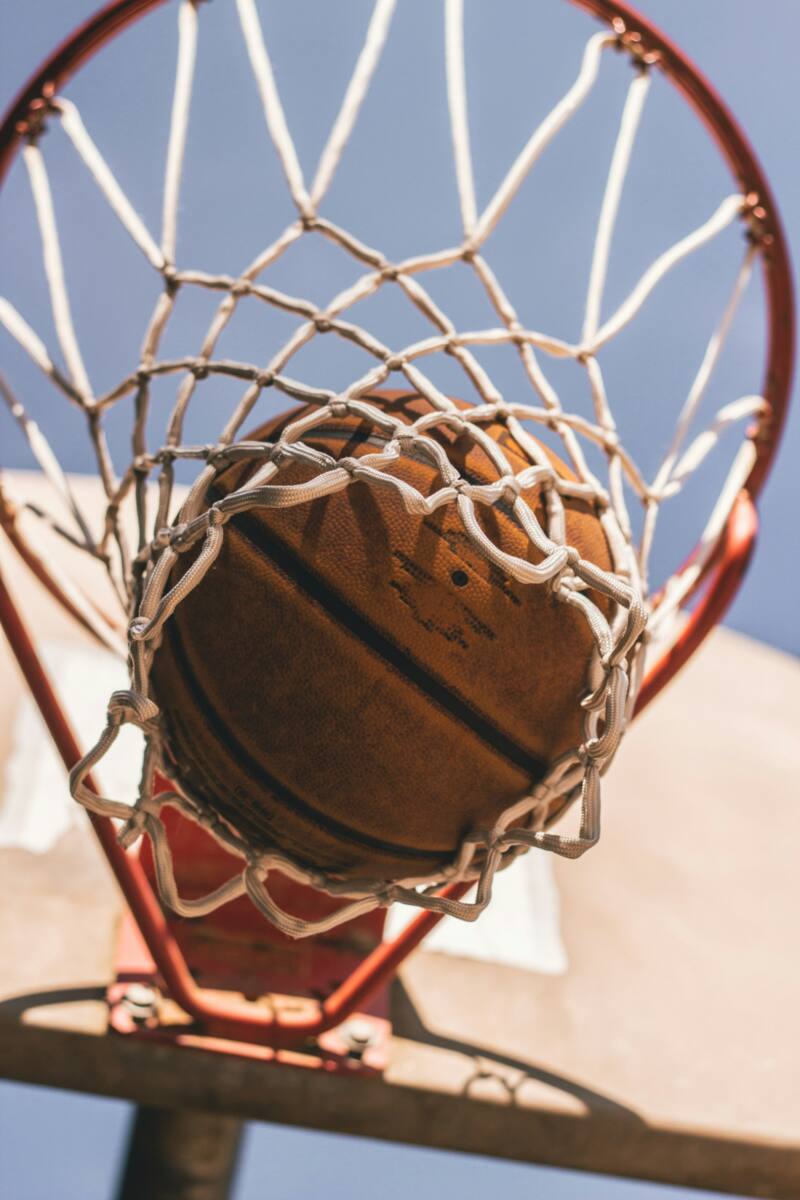 A basketball dropping through a hoop, representing college sports ncaa phone case fandom
