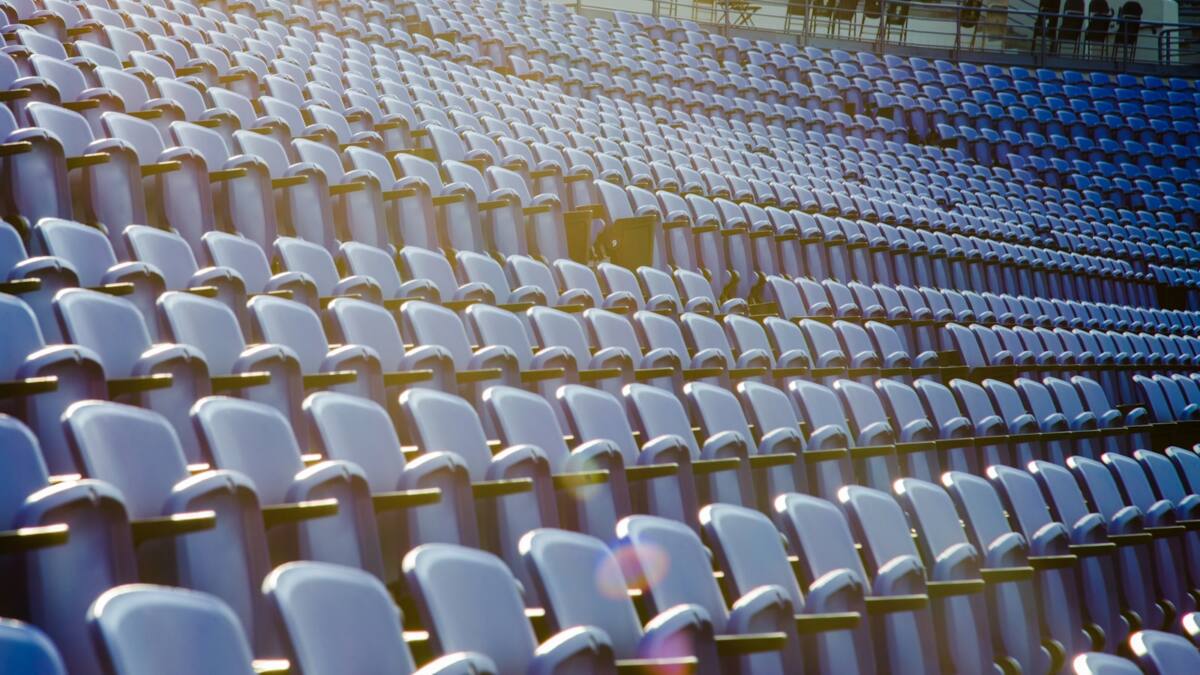 Sports fan game day phone case scene: empty stadium seating before kickoff