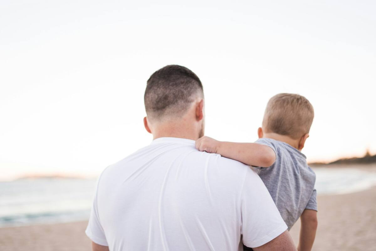 Father and son on the beach, one of the best phone case ideas for dad using a family photo