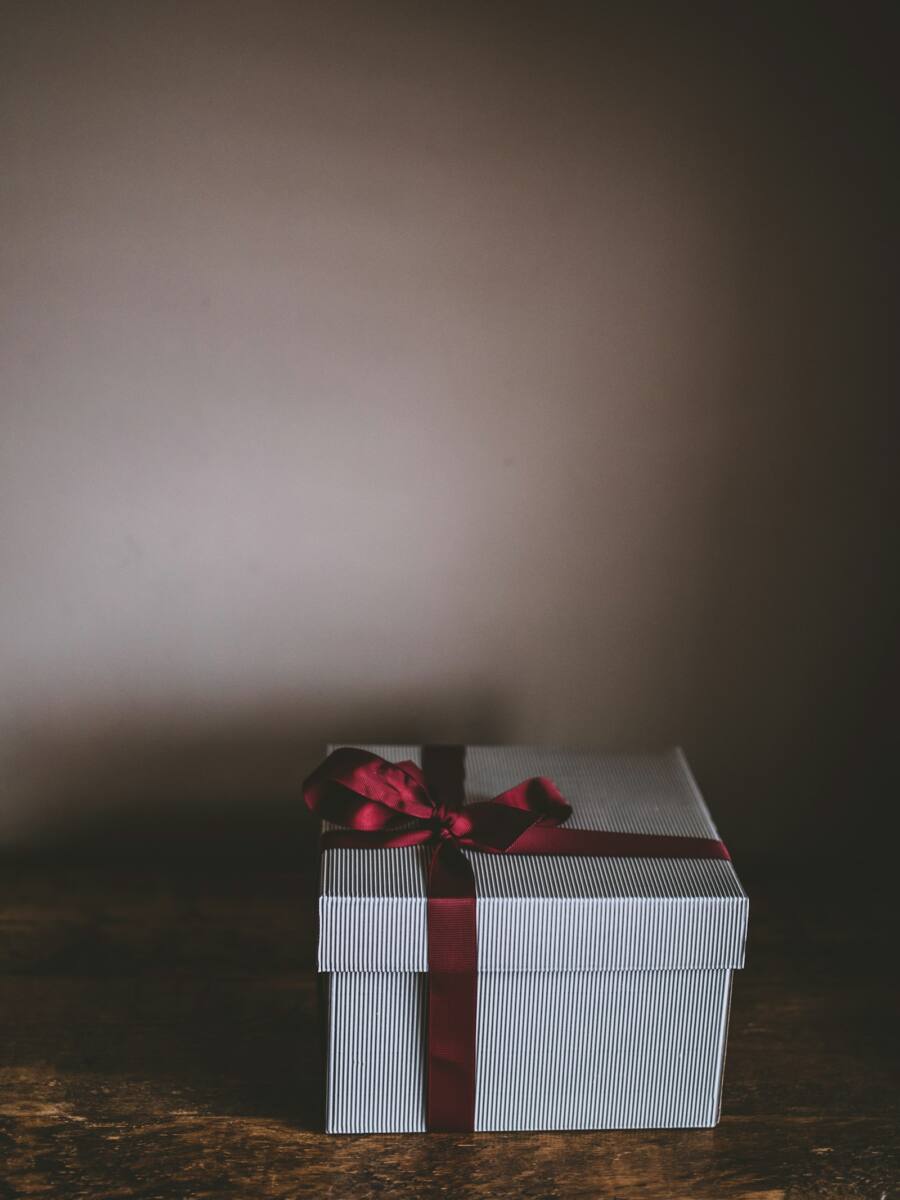 Striped gift box with red ribbon, an idea for pairing a phone case with a matching gift