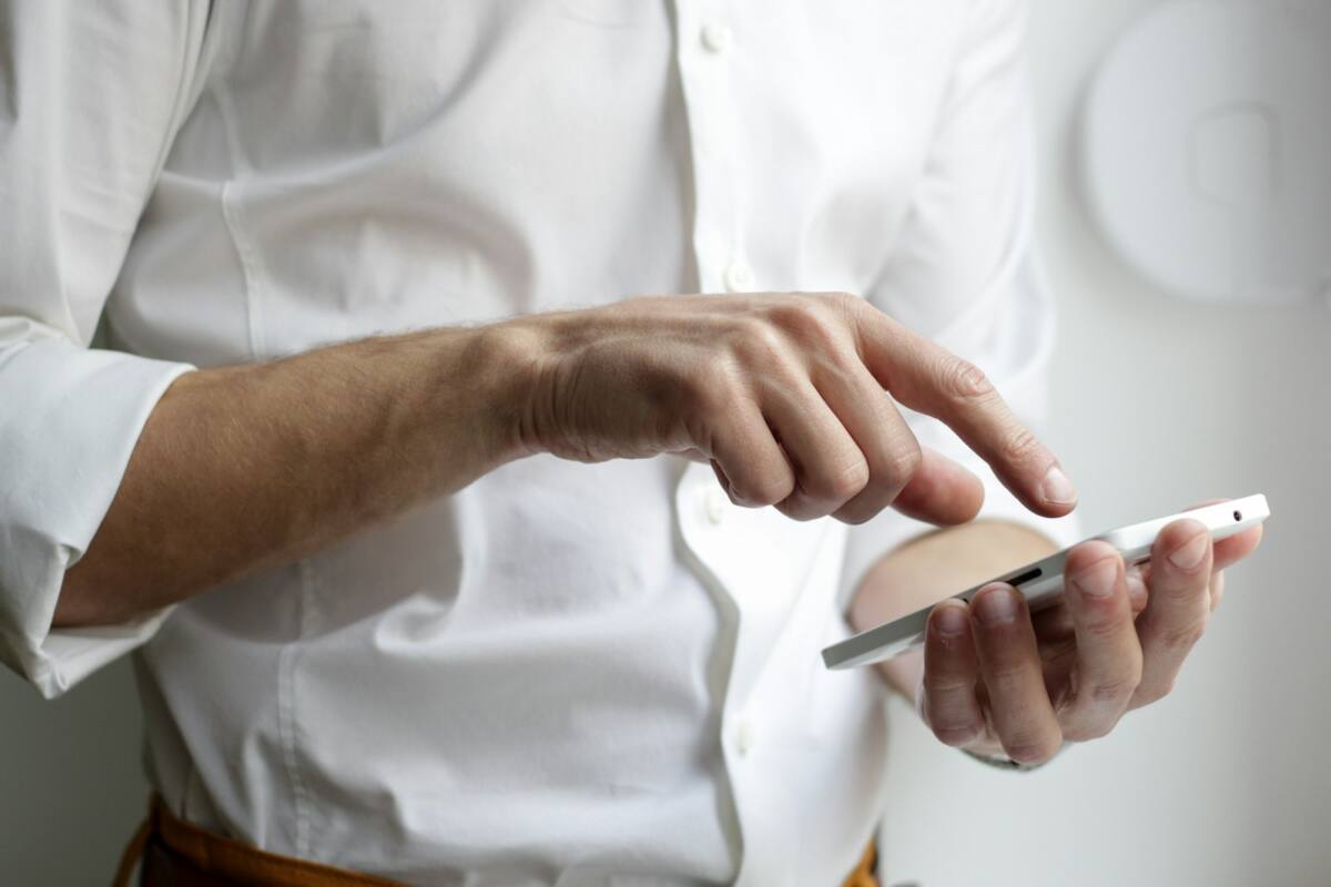 Hand quickly tapping a phone screen, designing a last-minute Father's Day phone case