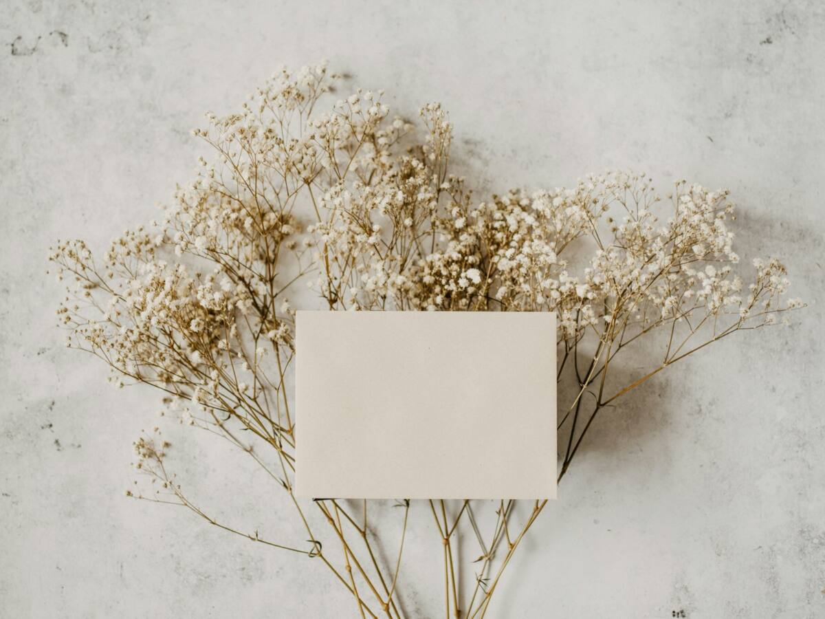 Blank cream card with dried baby's breath flowers, ready for a handwritten Mother's Day note