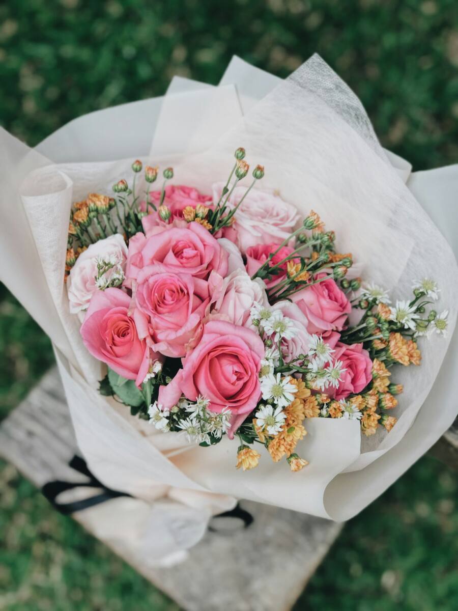Last minute mothers day phone case gift scene: pink and white rose bouquet wrapped in paper