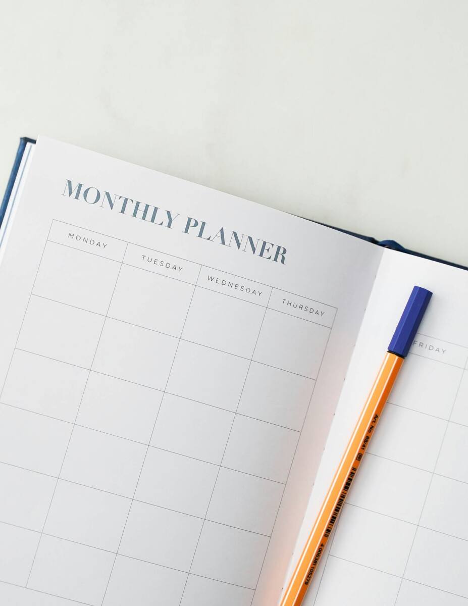 New year resolution phone case gift scene: open monthly planner with a pen, representing new year goals