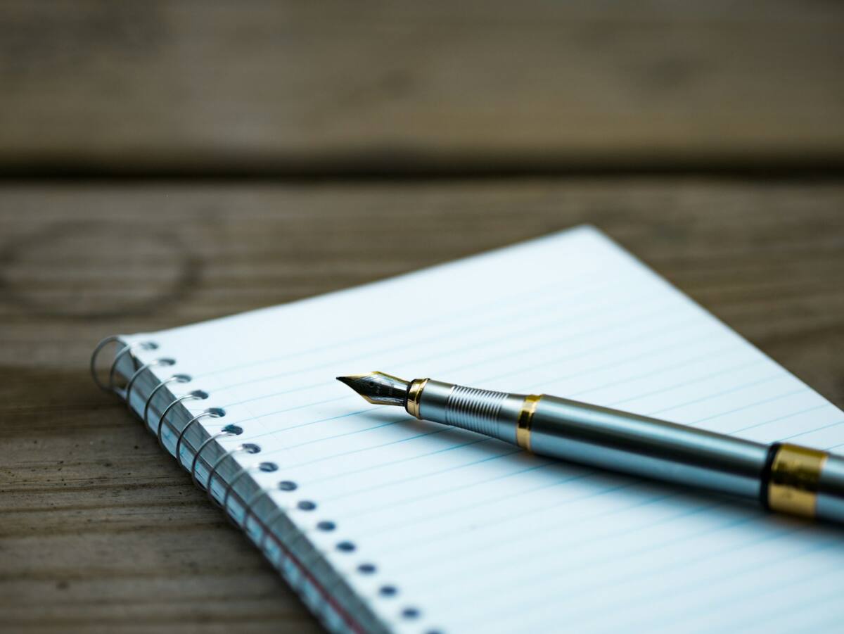 Notebook and pen on a wooden desk