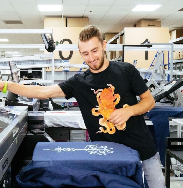 Print on demand warehouse worker preparing a freshly printed order for shipping