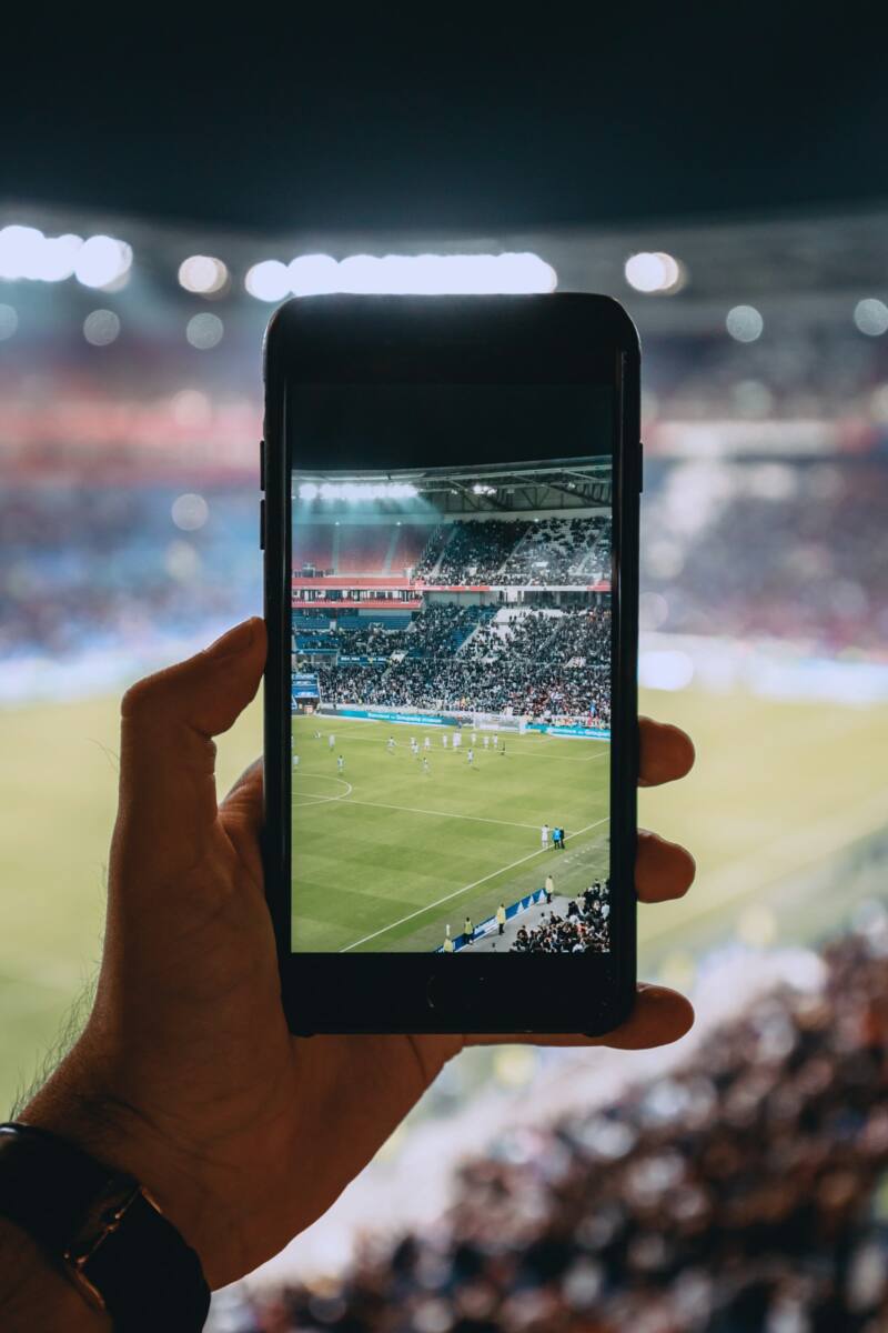 A soccer mls phone case theme shown through a phone held up at a match