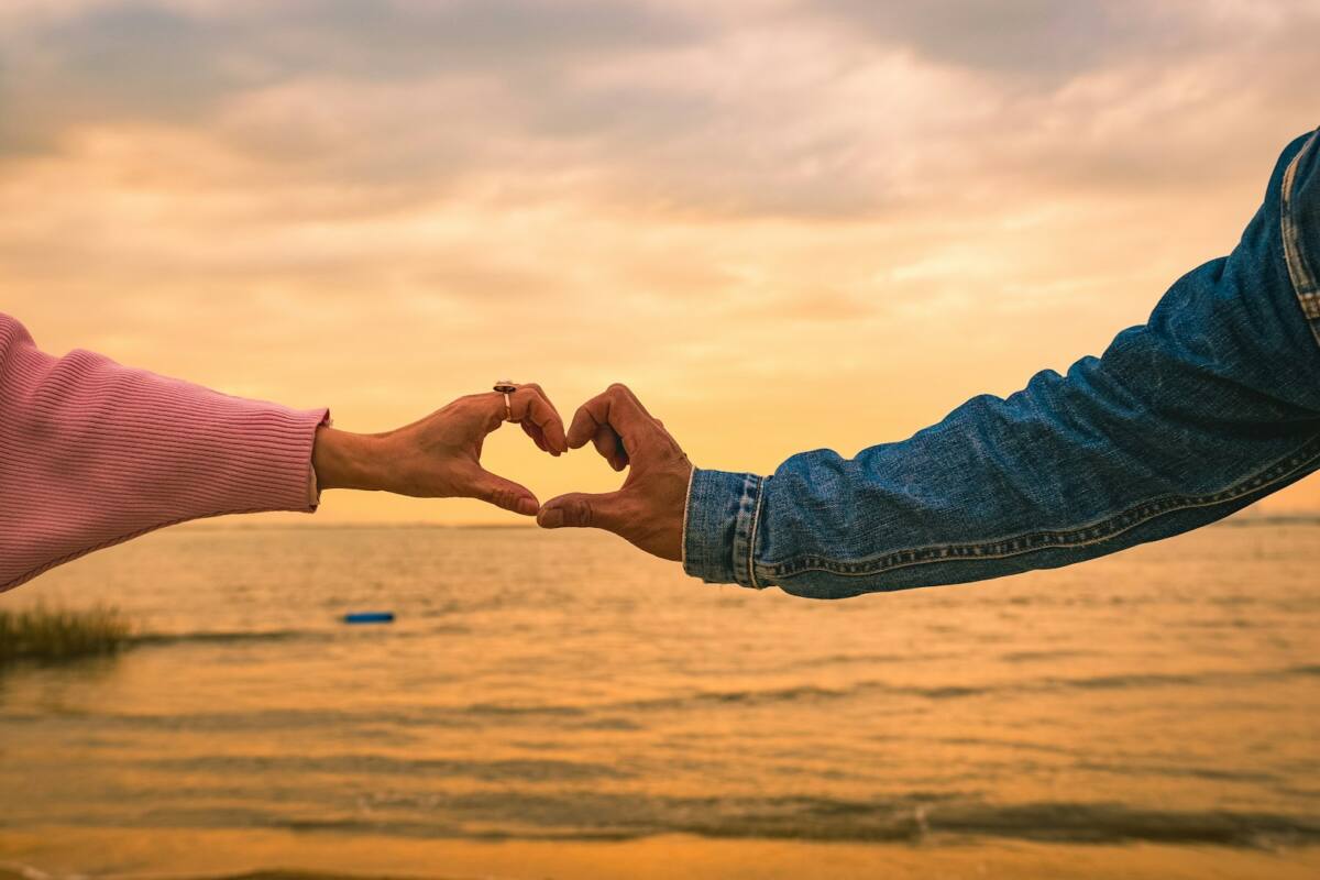 Valentines day phone case gift guide: two hands forming a heart against a sunset