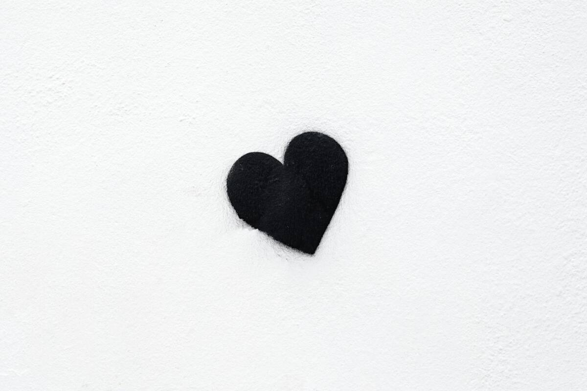 A single minimalist heart stencil on a white wall, representing a simple last-minute Valentine's Day phone case design